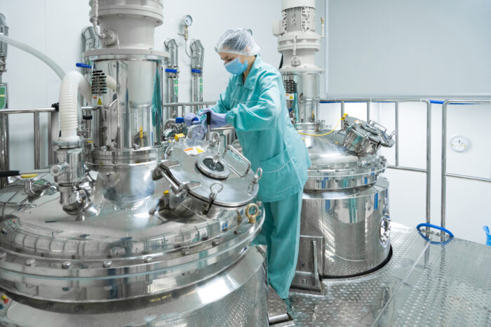 Pharmaceutical technician in sterile environment at pharmacy industry